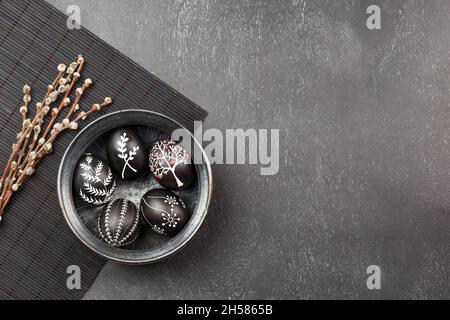 Black monochrome Easter greeting card with handmade wax dyed pysanka eggs in a bowl Stock Photo