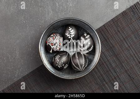 Black monochrome Easter greeting card with handmade wax dyed pysanka eggs in a bowl Stock Photo