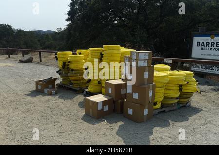 Cal Fire hose packs and associated valves await use at wildland fire east of San Diego, California. Stock Photo