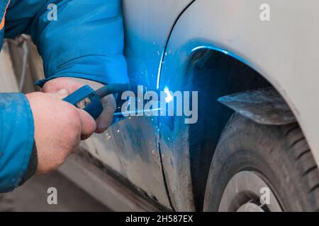 Welding and metal works repair of the car body. Stock Photo