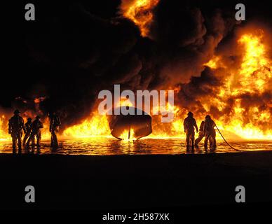 USMC Aircraft Rescue Fire Fighters working the flame pit at MCAS Miramar, San Diego, California. Stock Photo