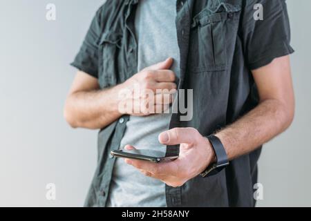 Casual man using smart mobile phone for communication, selective focus Stock Photo