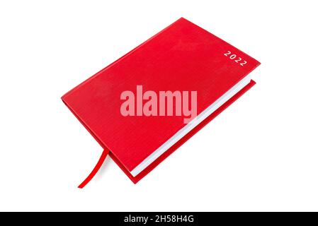 Closed red notebook with the words 2022 and a ribbon, isolated on a white background. Stock Photo