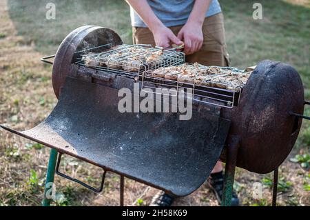grilled meat skewers chicken the meat holder over fire burned churcoal Stock Photo