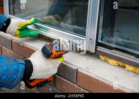 The wizard is engaged in installing windows. Repair work Stock Photo