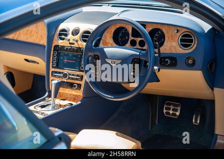 Steering wheel and dashboard of a Bentley GT Coupe viewed through the car's window Stock Photo