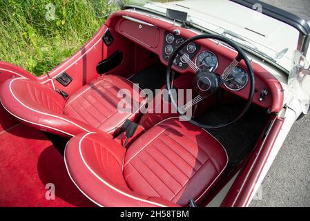 Cockpit of a Triumph TR3 classic sports car parked on a country lane Stock Photo