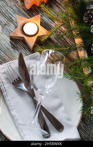 Christmas table setting with candles and fir branches Stock Photo