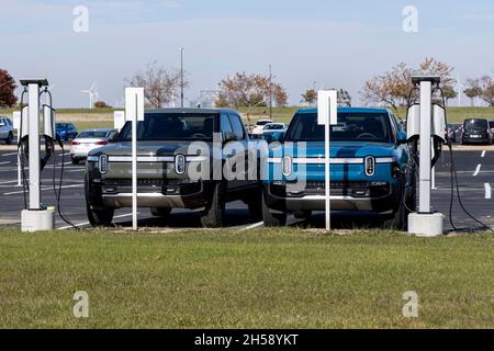 Normal, Illinois, USA. 7th Nov, 2021. A pair of R1T Rivian pickup trucks are hooked to charging stations in front of the Rivian company automotive assembly plant in Normal Illinois. Rivian builds electric vehicles including their premier vehicle the R1T pick up truck. Credit: Alan Look/ZUMA Wire/Alamy Live News Stock Photo