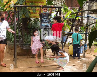 Malabon City, Philippines. 07th Nov, 2021. Kids seen playing at the Malabon Zoo.Malabon Zoo in the Philippines had a soft opening after closure due to Covid-19 pandemic. As Metro Manila downgrade to alert level 2 status. Manny Tangco, the zoo owner, calling for cash donations to fund the food of the animals. Credit: SOPA Images Limited/Alamy Live News Stock Photo