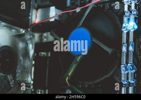 RAM memory in computer motherboard with blue light. Inside desktop PC plenty of dust. PC system. Computer hardware. Electronic chip. PC RAM, and fan Stock Photo