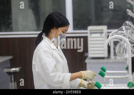 Vietnamese woman scientist washing equipment in the laboratory Stock Photo