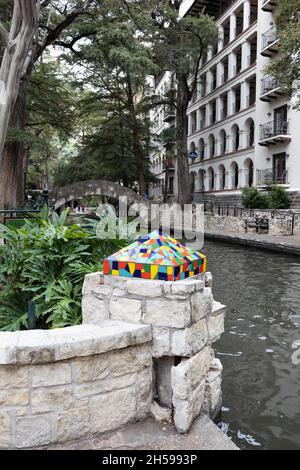 A colorful mosaic 'cap' on a rock wall along the riverwalk in San Antonio, Texas. Stock Photo