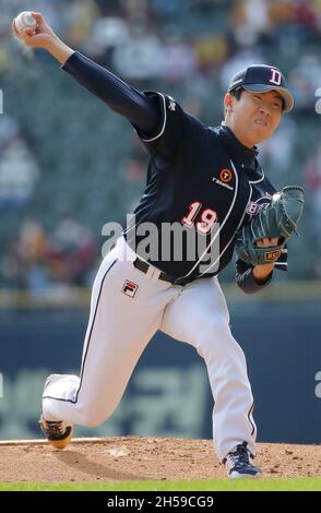 IU throws the opening pitch for the Doosan Bears