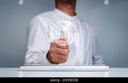 Fingerprint scan action with fingerprint scan technology icon with businessman's thumb for digital security access with biometrics identification. Bus Stock Photo