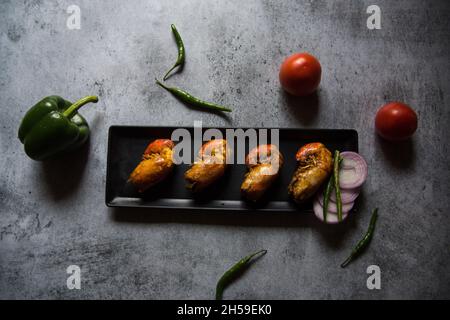 Fried prawns on a black tray with use of selective focus Stock Photo