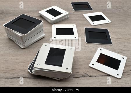 Old slides on wooden table. Vintage 35mm slide film Stock Photo