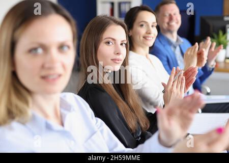Workers in presentable suits sit in room Stock Photo