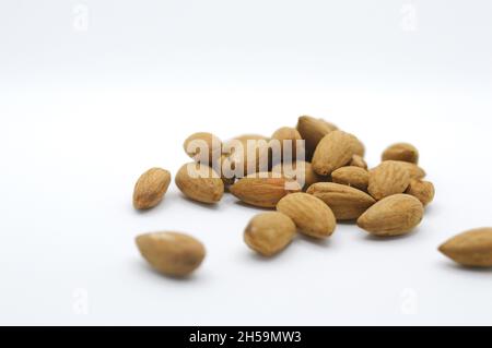 Raw organic healthy almonds on horizontal white backdrop Stock Photo
