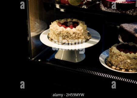 delicious cream cake with almond chips on display Stock Photo