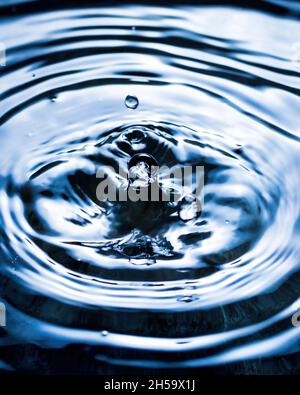 Splashes of water and blurry waves on it. Stock Photo