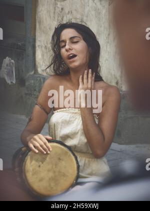 street music in Istanbul young woman Michal Elia Kamal percussionist, singer and song writer of “Light in Babylon”, Turkey July 2010 Stock Photo