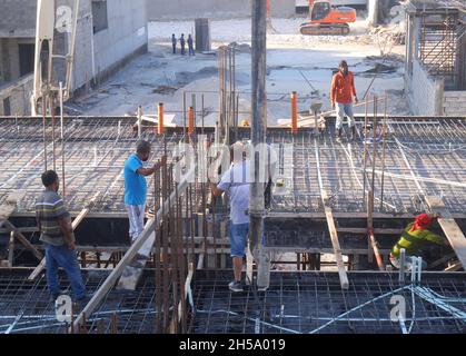 Asian construction workers working on a building, Kingdom of Bahrain Stock Photo