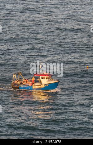 Fishing boat P29 Spirited Lady working as the sun sets over Newquay Bay on the North Cornwall coast. Stock Photo
