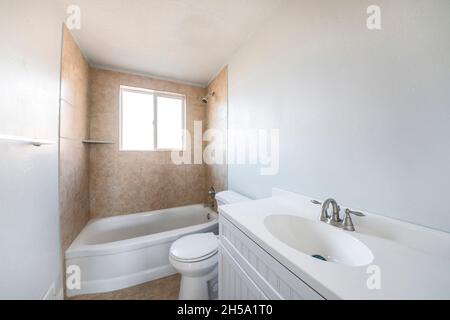 Interior of a bathroom with window on top of a bathtub Stock Photo