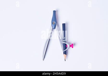 Drawing Compass with pencil on white background. A school compass with a blue pencil on white backdrop Stock Photo
