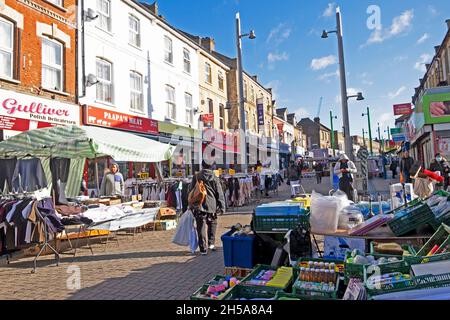 Walthamstow High Street market stalls, shops people shopping in autumn sunshine October 2021 London England UK Great Britain  KATHY DEWITT Stock Photo