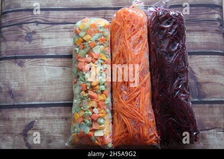 Grated beetroot, grated onion and cut and packaged vegetables and legumes. View from above. With space for text. Stock Photo
