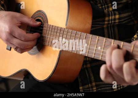 acoustic guitar in the hands of a man Stock Photo