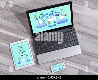 Communication concept shown on different information technology devices Stock Photo