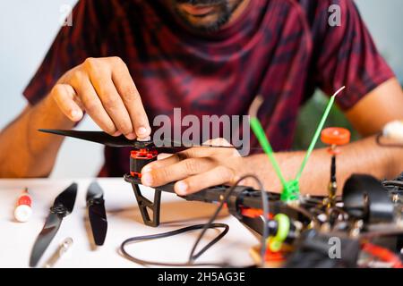 Close up shot of hands instalilng propeller to Quadcopter - concept of drone assemble and reparing UAV Stock Photo