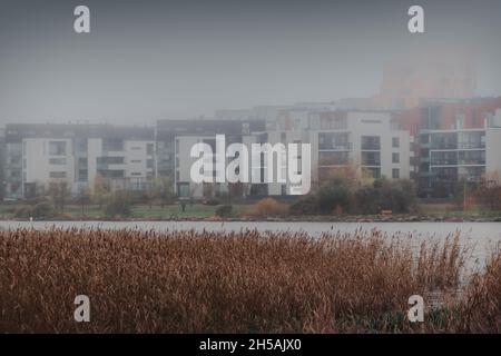 Foggy November. Misty weather at city. Residential apartment buildings in a fog on a rainy autumn day. Scandinavian lifestyle. Helsinki, Finland. Stock Photo