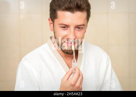 Young caucasian man receiving nasal inhalation Maholda with essential oil in the nose at a hospital Stock Photo