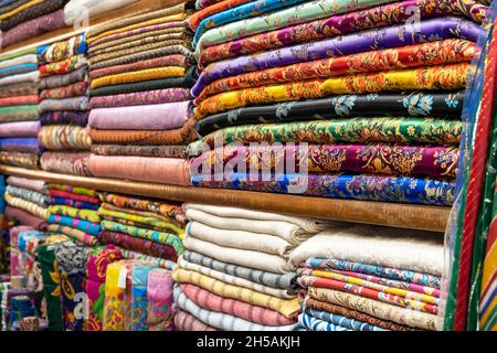 Colored textile or fabric at a street Asian Market, shelves with rolls of fabric and textiles Stock Photo