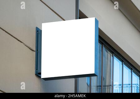 Mock up. Blank white rectangular shape signboard on the wall outdoors. Signage of shop, store, cafe, restaurant Stock Photo