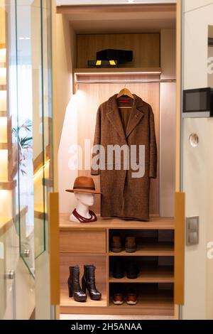 Not a large modern dressing room. Interior design, wardrobe. Stylist's work. Soft selective focus, artistic noise. Stock Photo