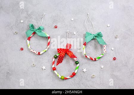 Christmas wreath ormaments from paper straw. Step by step instructions. Step 10 finished result. DIY craft for children. Hobbies at home. Stock Photo