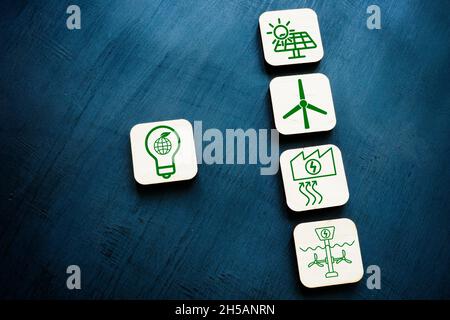 Renewable resources or green energy concept. Wooden cubes on the dark surface. Stock Photo