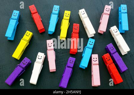 Multicolored clothespins with happy faces. Variety and diversity concept. Stock Photo