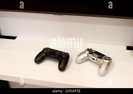 Two joysticks for video games on the nightstand. Modern technologies. Soft selective focus. Stock Photo