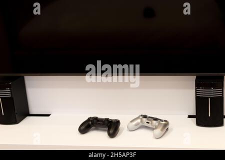 Two joysticks for video games on the nightstand. Modern technologies. Soft selective focus. Stock Photo