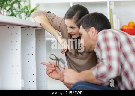 plumber looking at damages sink pipe Stock Photo