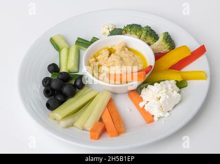 Mediterranean vegetables with hummus dip on white plate Stock Photo