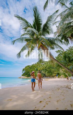 Surin beach in Phuket, southern of Thailand, famous tourist destination in Phuket, Beautiful beach, View of nice tropical beach with palms around. couple man and woman on beach Stock Photo