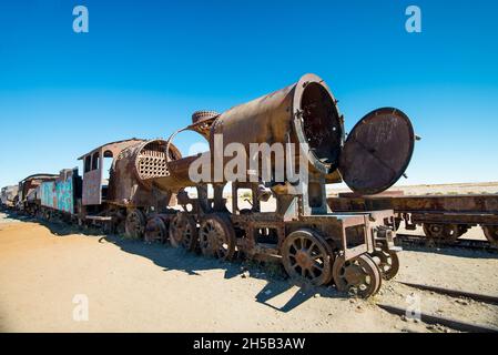 Rusty old steam train in Bolivian desert - train cemetery in Uyuni Stock Photo