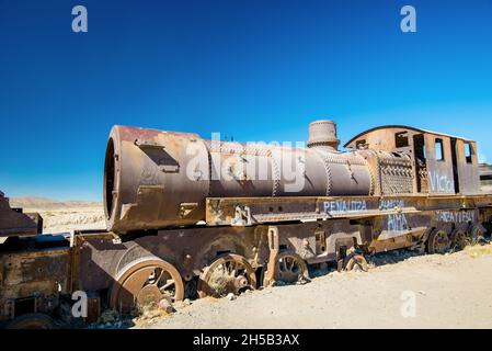 Rusty old steam train in Bolivian desert - train cemetery in Uyuni Stock Photo